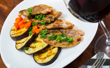 Tasty mutton loin chops grilled with eggplant slices and carrots garnished with fresh parsley