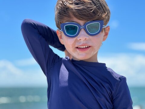 boy wearing goggles in the beach in south florida cocoa beach 
