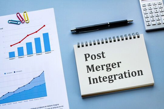There is wood cube with the word Post Merger Integration. It is an abbreviation for Post Merger Integration as eye-catching image.