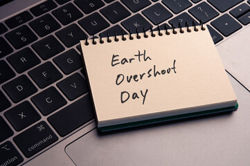 There is wood cube with the word Earth Over Shoot Day. It is an abbreviation for Earth Over Shoot Day as eye-catching image.