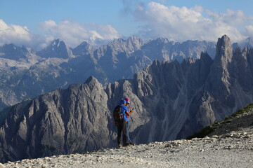 Hikers talking on the mountain trail in dolomites