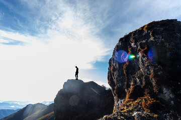 hiker on top of a rock in the middle of the paramo in Chirripo National Park in Costa Rica