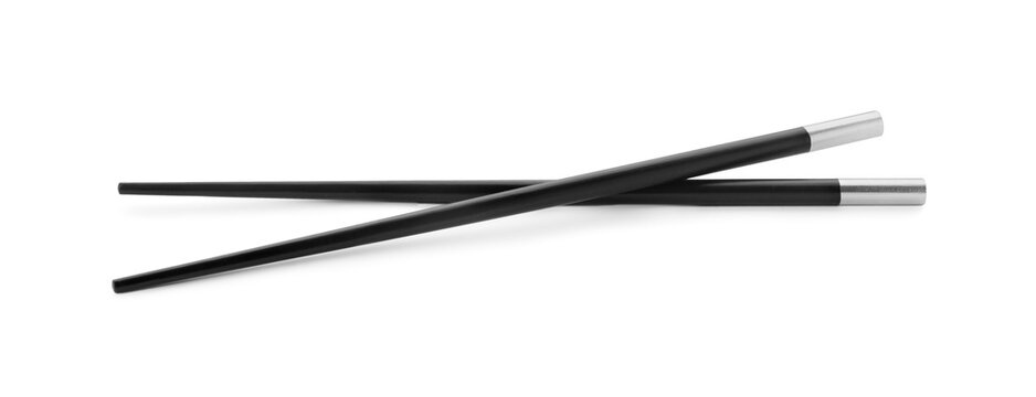 Pair of black chopsticks isolated on white