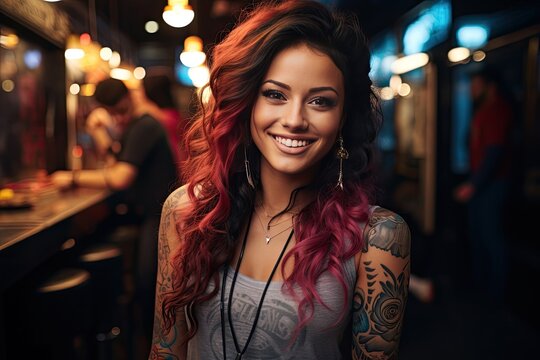 Young latina woman portrait with tattoo on shoulder standing on city street in evening. In background there are city lights.