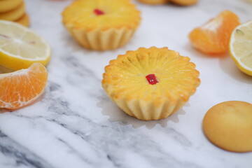 Lemon tartlets with fresh lemons and tangerines.