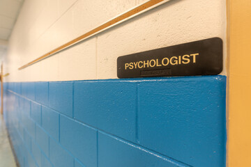 Psychologist Office, counselor office, sign with braille, on a white and blue wall at door to...