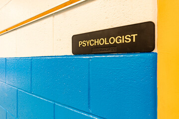 Psychologist Office, counselor office, sign with braille, on a white and blue wall at door to...
