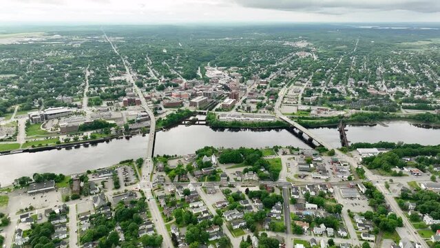 Wide drone shot of Bangor, Maine with the Penobscot River cutting through the city.