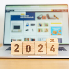2024 Year block against marketplace website. Goal, Target, Resolution, finance, E commerce, online...