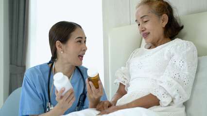 Fototapeta premium Nurse is explaining taking the medicine and consulting for treatment. Concept of wellness consultation, caregiver, elderly healthcare and homeopathic doctor.