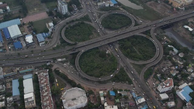 The Maduravoyal flyover bridge in Chennai can be seen from above, along with nearby structures and moving traffic.