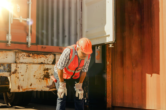African American male workers suffer dehydration heatstroke thirst dizziness headache nausea rapid breathing vomiting unbearable dizziness in the hot weather in the container yard.