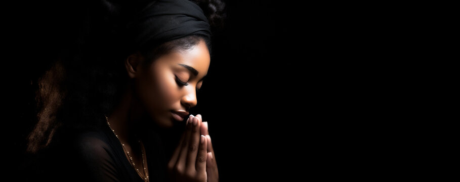 Soulful Devotion: Christian Woman in Prayer - Embracing Faith on a Reverent Black Canvas.