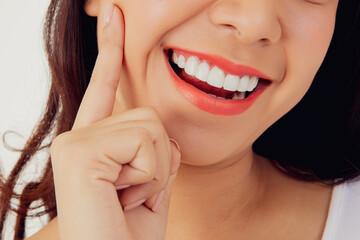 Obraz premium Asian woman with beautiful teeth : Closeup young woman's face with healthy teeth white clean beautiful smile : Happy woman taking care of her teeth perfectly : Oral care dentistry concept.