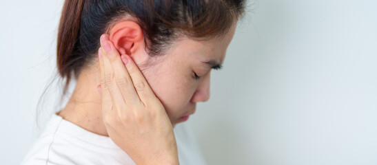 Woman holding her painful Ear. Ear disease, Atresia, Otitis Media, Inflation, Pertorated Eardrum,...