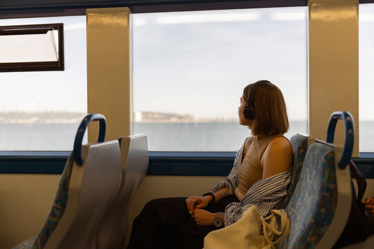 Woman tourist traveling in public transport and looking view outside the window. High quality photo