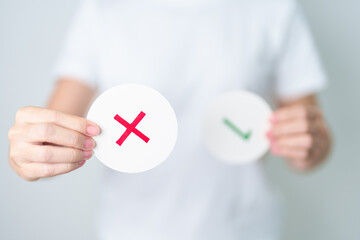 Woman show Wrong symbol paper. True and false, accept and rejected, evaluation, Vote, Poll, Yes or...