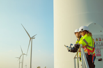 Technician working outdoors, wind farm professional team male and female safety uniform ready to...