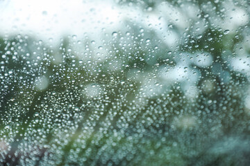 Raindrops on window, a poetic embrace of solitude and renewal. Symbolizes nature's teardrops painting introspective moments on a rainy canvas