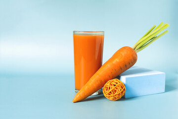 Fresh carrot juice and sweet carrots close-up on a light background