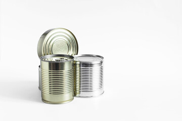 Tin cans with various products close-up on a white background. Long-term storage products.