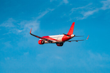 Passengers Commercial airplane flying above dramatic clouds. Concept of fast travel, holidays and business. Commercial transportation concept