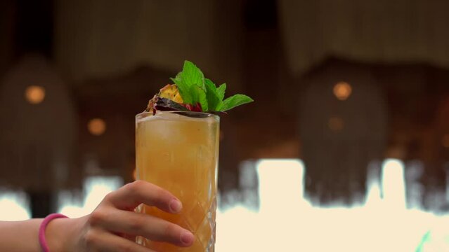 Woman bartender female mixologist show present drink at beach latin mexico mexican restaurant sunset fresh mojito daiquiri citrus glass lady beauty smile