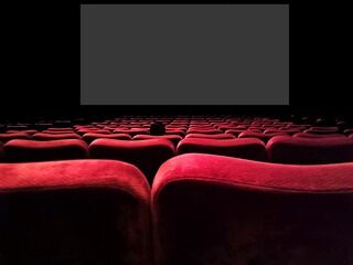 Inner view of a movie theater with rows of red audience seats.