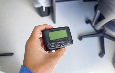 Pager's presence signifies instant connection: modern communication's emblem, bridging distances, conveying urgency, and shaping era-defining connections