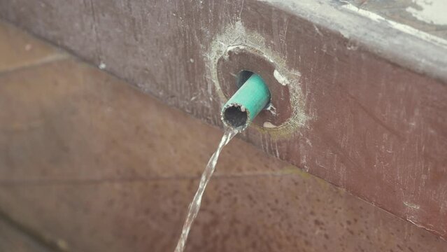 Boat bilge water pumped out of through-hull. Close Up