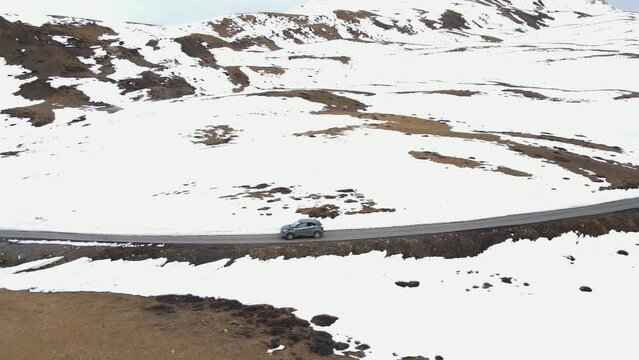Spiti district of Himachal Pradesh  World's Highest Village india Komic  indian tourist driving a car along the mountains road, aerial view 