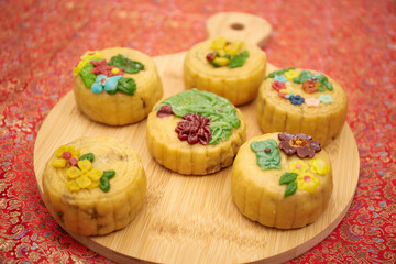 Close-up image of woman serving mooncakes on the table with tea