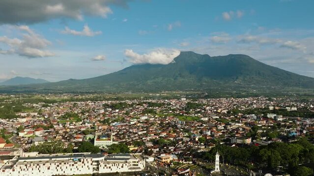 The city of Bukittinggi and Mount Marapi. A clock tower Jam Gadang. Sumatra. Indonesia.