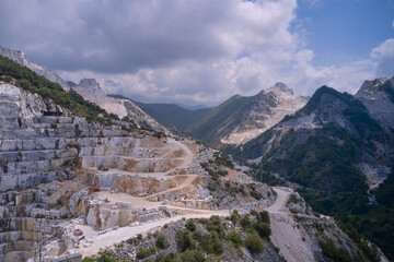Industrial machinery in a quarry. Aerial panorama of marble quarries Carrara Italy. Marble quarry...