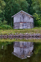 Old boathouse in river bank