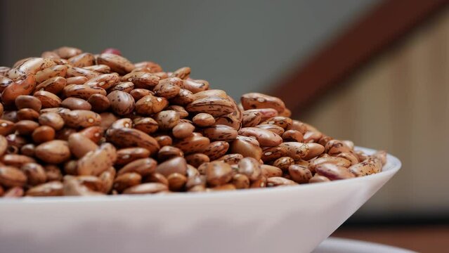 There are nuts on a plate and in a bowl at the wedding reception