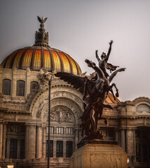 Primer plano de estatua frente a fachada de Palacio de Bellas Artes en la Ciudad de México