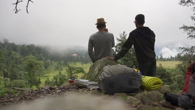 Two friends take tea on mountain,Almora, Uttarakhand, India.