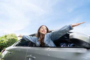 Young beautiful asian women getting new car. She relaxing out of window in a car - Freedom car...