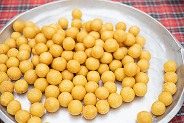 Many swan egg snacks are placed in a stainless steel tray.