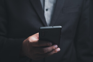 Businessman hand holding and using smartphone, tablet, cell phone touching on screen. mobile phone application technology. copy space for text.