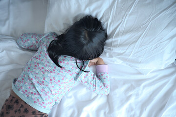 a child sleeping on bed 