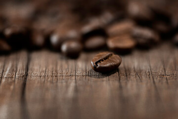 Roasted coffee beans on old wood table for background