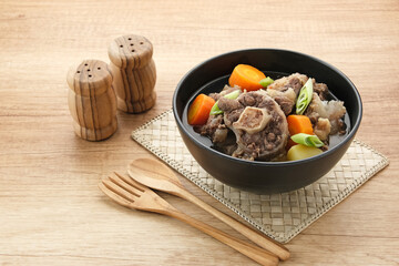 Sop Buntut or Oxtail Soup with carrot and potatoes. Indonesian traditional food
