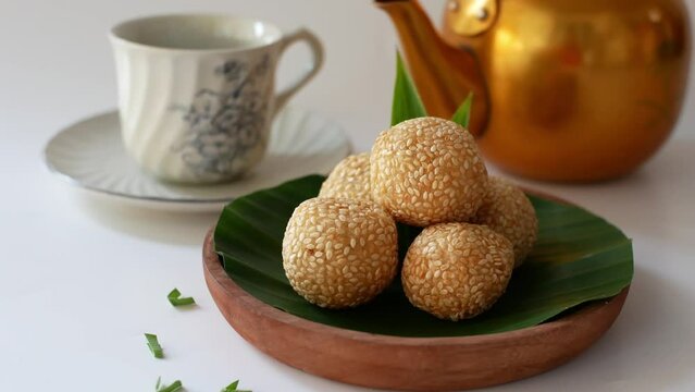 onde onde or sesame seed ball on a plate with banana leaf, popular traditional food in Indonesia