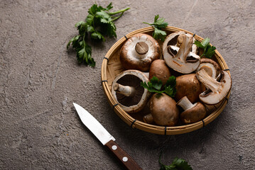 Raw champignon mushrooms on black background