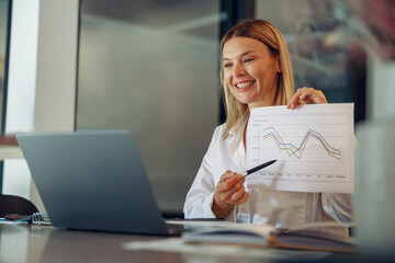 Business woman present financial data or BI paper via laptop during online meeting. Distance work