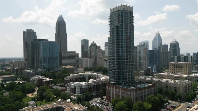 Ascending Drone Shot of Sunny Charlotte City Skyline with Skyscraper in Foreground