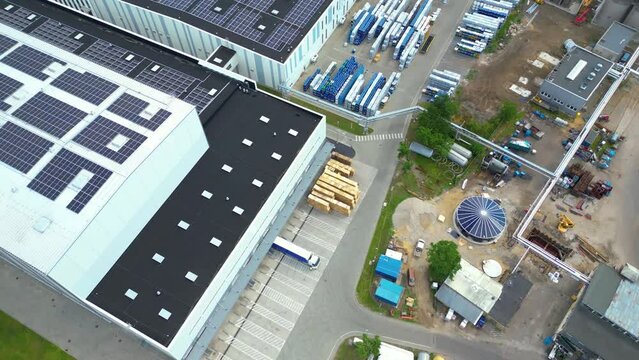 Aerial view of distribution center, drone photo of industrial logistics zone,new super modern logistics center full of modern technology and robotics,roof solar power plant for green energy production