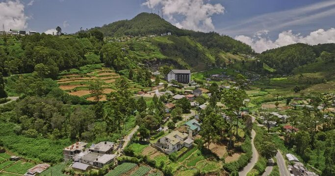 Nuwara Eliya Sri Lanka Aerial v2 low level drone flyover along A5 PBC highway capturing hillside accommodations in Bambarakelle with hilly mountain landscape view - Shot with Mavic 3 Cine - April 2023
